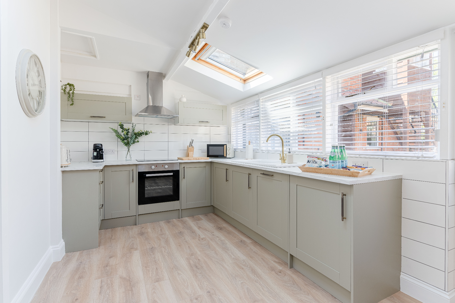 Bright modern kitchen with skylight and neutral cabinetry